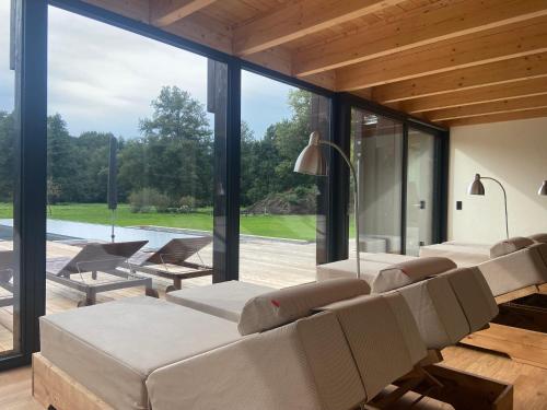 a living room with white furniture and large windows at NaturApartments - Hideaway & Spa in Burg