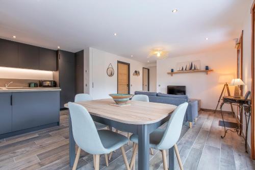 a kitchen and dining room with a wooden table and chairs at Le Samance 1 in Le Grand-Bornand