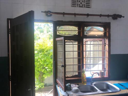 a kitchen with a sink and a window at Safariadventures-House in Arusha