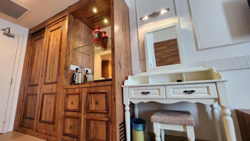 a bathroom with a sink and a wooden door at Swan Garden Hotel in Melaka