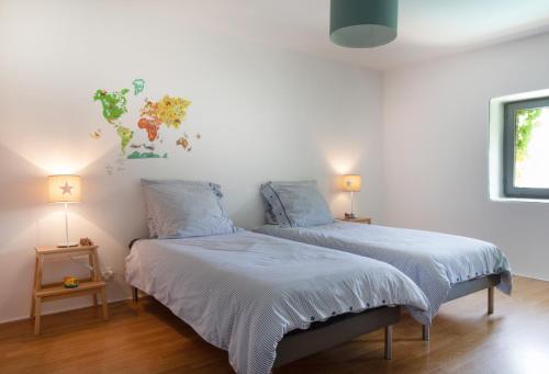 two beds in a room with two lamps at Maison du bonheur 10pers Piscine Privee et Chauffee in Grignan