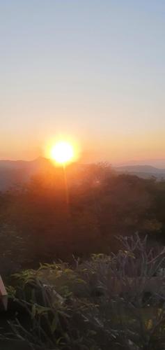 a sunset with the sun setting in the horizon at Sun view in Nelspruit