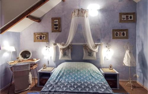 a bedroom with a blue bed with a canopy at Pet Friendly Home In Marsac Sur Don in Marsac-sur-Don
