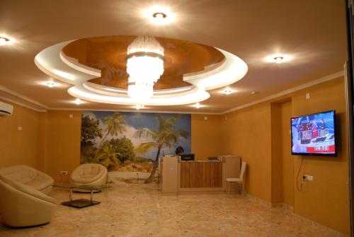 a lobby with a large room with a television and a ceiling at Hotel Exotica in Ureki
