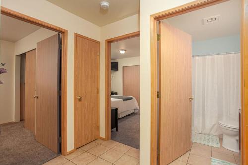a bedroom with a bed and a bathroom with a toilet at Walk to Downtown Leavenworth * Sleeps 6 + Pets * Ground Level Gem! in Leavenworth