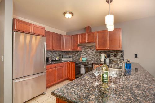 a kitchen with wooden cabinets and a granite counter top at Walk to Downtown Leavenworth * Sleeps 6 + Pets * Ground Level Gem! in Leavenworth