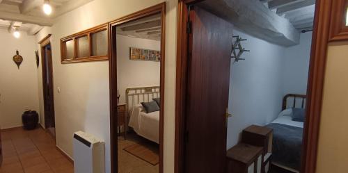 a hallway with a room with two beds and a door at Casa de la Cigüeña in Candelario