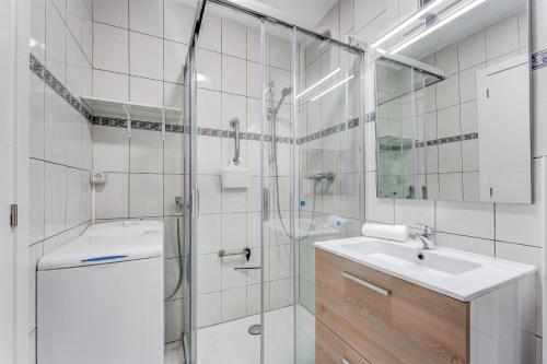 a bathroom with a shower and a sink and a mirror at Los Cristianos Achacay Bluesky Apartment in Los Cristianos