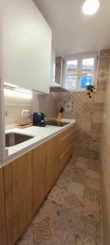 a kitchen with a sink and a counter top at Premium Apartment PLAZA MAYOR in Salamanca