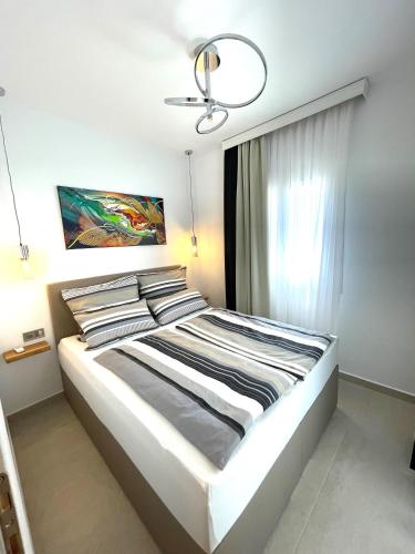 a large bed in a bedroom with a window at Villa Lifestyle & Trends in Limenaria