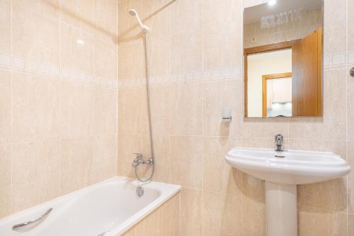 a bathroom with a sink and a toilet and a mirror at Paraiso Lido Sea Views 1-D Levante Beach in Benidorm