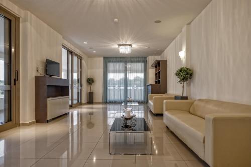 a living room with a couch and a table at Lagomandra Beach Hotel in Lagomandra