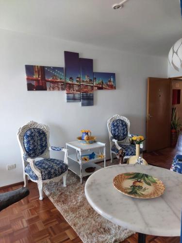 Moderno dpto con vista a la bahía de Asunción في أسونسيون: غرفة معيشة مع كرسيين وطاولة