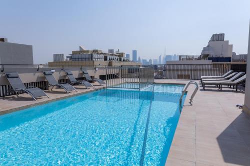 a swimming pool on the roof of a building at Azur Regency Hotel Apartments in Dubai