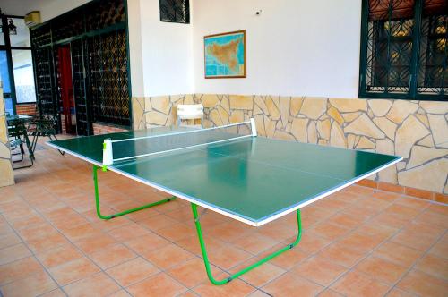 a green ping pong table in a room at Angelo Delle Aci in Acitrezza