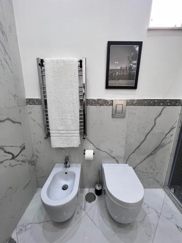a bathroom with a white toilet and a bidet at RaRoom Supernova H in Torre del Greco