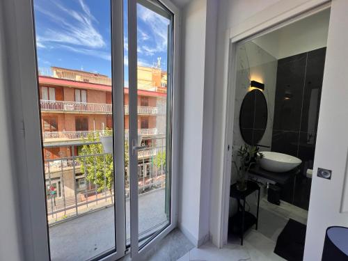 a bathroom with a window with a view of a building at RaRoom Supernova H in Torre del Greco