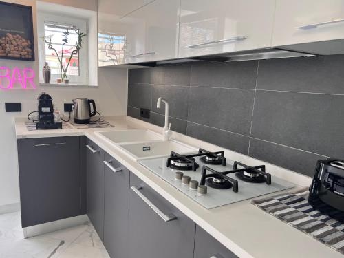 a kitchen with a stove top oven next to a counter at RaRoom Supernova H in Torre del Greco