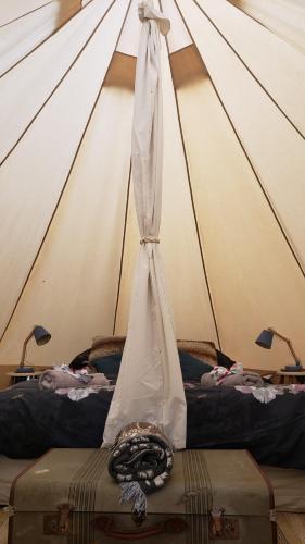 a tent with two beds in a room at Tui site in Waihi