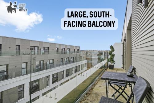 a balcony with a table and a building with the words large south facing balcony at Lux Penthouse Flat in Stevenage with Balcony, Super King Bed & Fast WiFi in Stevenage
