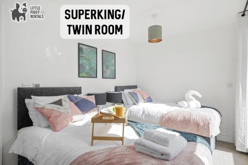 two beds in a room with the words surprising twin room at Lux Penthouse Flat in Stevenage with Balcony, Super King Bed & Fast WiFi in Stevenage