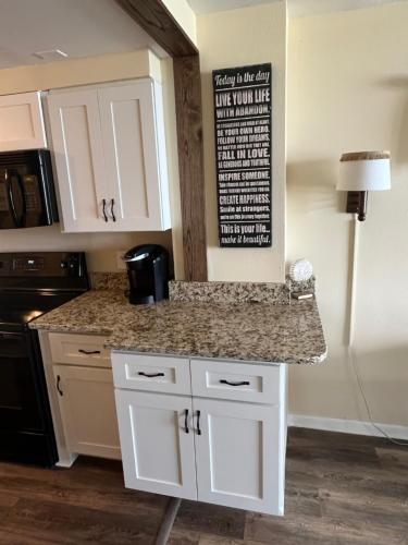 a kitchen with white cabinets and a granite counter top at Ocean Dream Vacation in Myrtle Beach