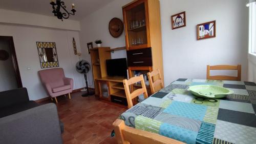 a dining room with a table and chairs and a room with a television at El Mirador de Cadiz in Cádiz