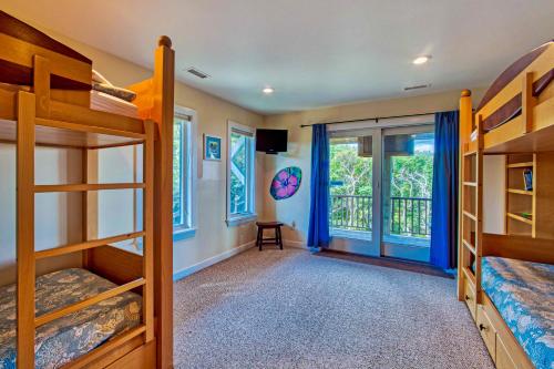 a bedroom with bunk beds and a balcony at Croatan Ridge 940 in Buxton