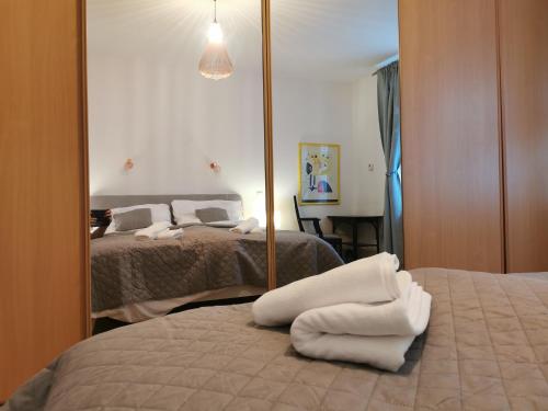 a bedroom with two beds and a mirror at CozyHome The Castle Apartment - Spacious, quiet, high ceiling in Bratislava