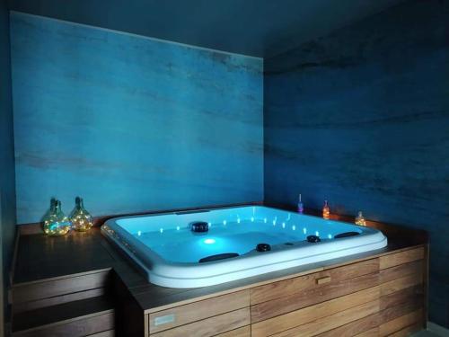 a bath tub in a room with a blue wall at Agriturismo Casale Lisalola in Sutri