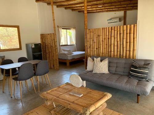 a living room with a couch and a table at Casas Lua & Mar - Vichayito - Máncora in Vichayito