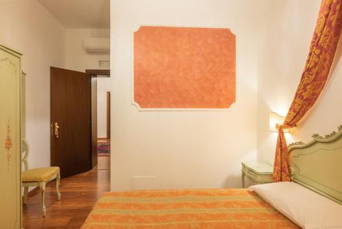 a bedroom with a bed and a painting on the wall at Hotel al Sotoportego in Venice