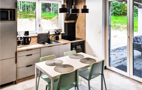 a kitchen with a table and chairs in a room at Amazing Home In Staniszów With Wifi in Staniszów