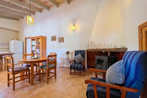 a living room with a table and chairs and a fireplace at FINCA SA SINI in Búger
