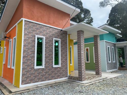 a small house with colorful at Damai Homestay in Kampong Jabi