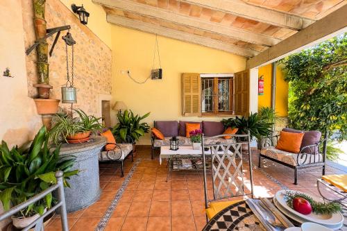 an outdoor patio with furniture and plants on a building at FINCA SA SINI in Búger