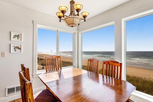 a dining room with a table and views of the ocean at Sand Castle 1 in Rockaway Beach