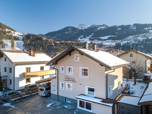 a view of a building with snow on the roofs at Arenablick in Zell am Ziller