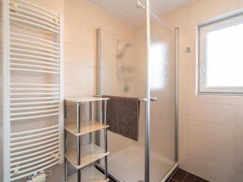 a bathroom with a shower and a glass door at Arenablick in Zell am Ziller