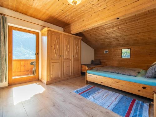 a bedroom with a bed in a wooden room at Apartment Schragl in Zell am Ziller