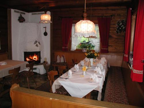 a dining room with a table and a fireplace at Almstüberl - Schiestl's Ferienhütten in Mayrhofen