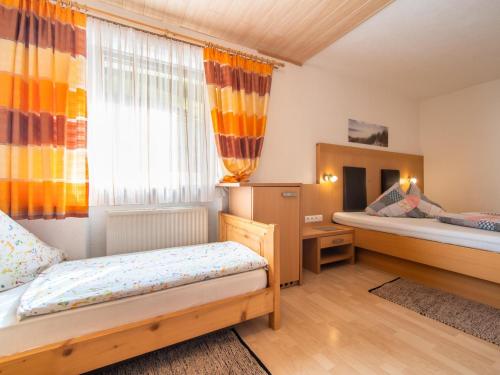 a bedroom with two beds and a window at Haus Hauser in Tobadill