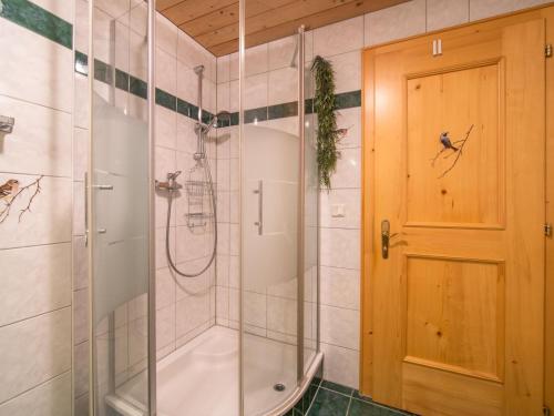 a bathroom with a shower and a glass door at Susanne in Bürserberg
