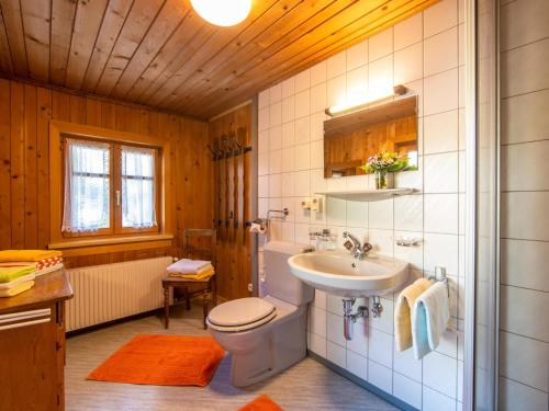a bathroom with a toilet and a sink and a tub at Landhaus Barbara in Silbertal