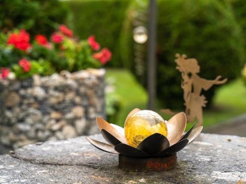 a small statue of a flower on a rock at Apartment Larcher in Hinterburg