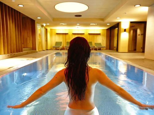 a woman is standing in a swimming pool at Klassik in Burg
