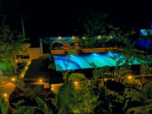 a view of a pool at night at Levona Garden Resort in Habarana