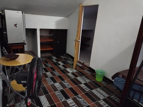 a room with two chairs and a table and a floor at The Red Hut Inn in Belize City