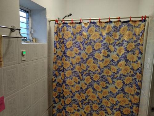 a blue and yellow shower curtain in a bathroom at The Red Hut Inn in Belize City