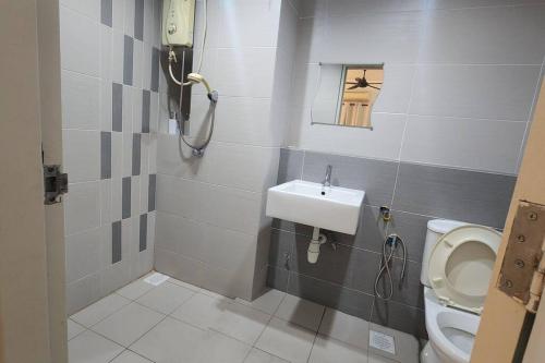 a small bathroom with a toilet and a sink at Netflix High Speed Internet 9pax Cinema Theme house Setiawalk with pool in Puchong